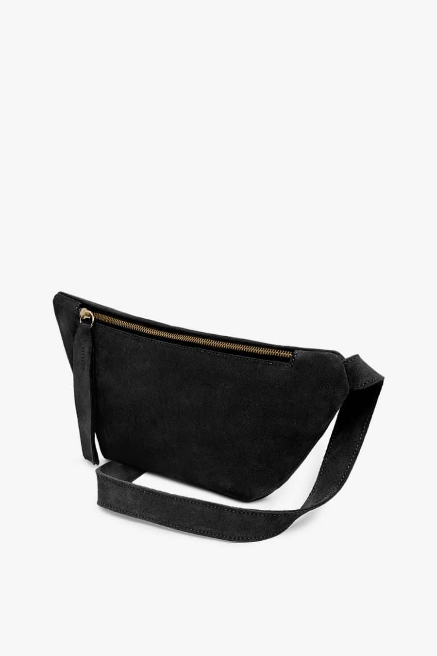 Black suede fanny pack or cross body bag with a strap on a white background