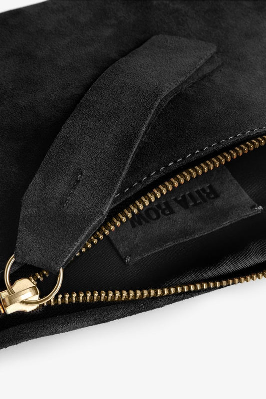 Black suede fanny pack style bag with gold zipper on a white background