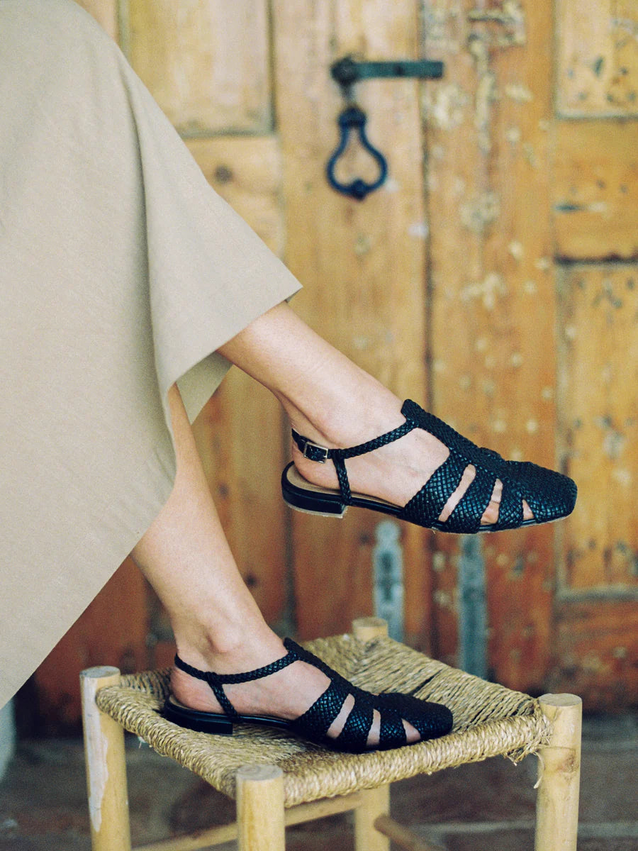 updated Fisherman sandal with buckle closure & three straps across the foot in woven black leather.