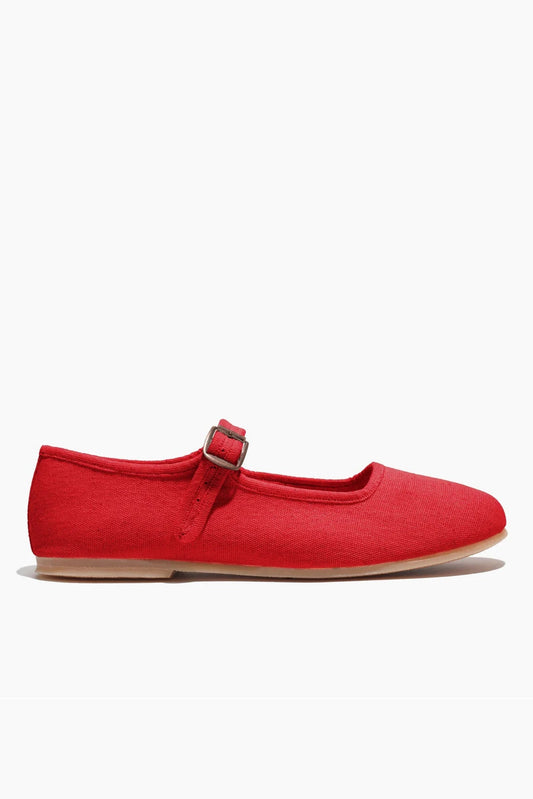 Red flat shoe with a strap on a white background