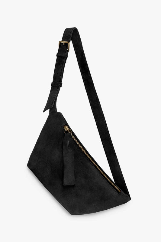 Black suede shoulder bag with a strap amd gold buckle on a white background
