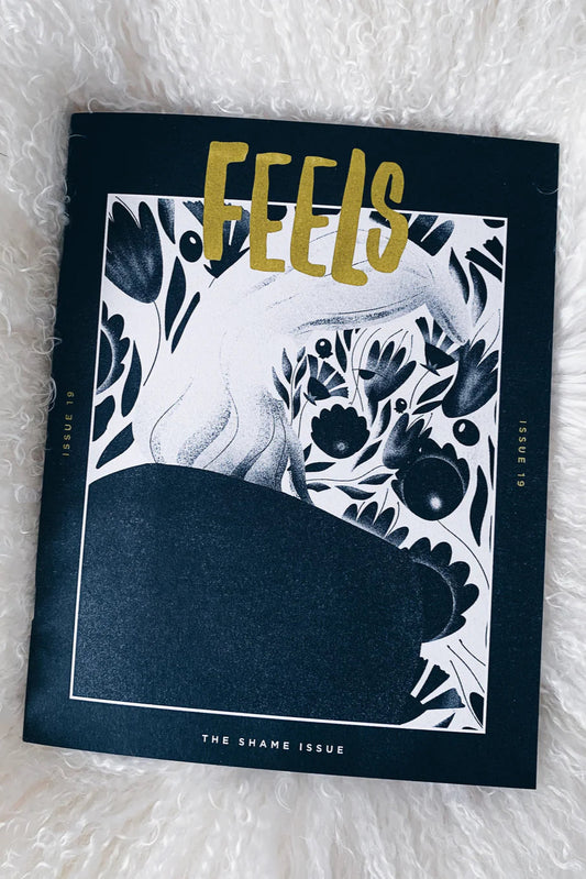 A magazine cover of 'FEELS' with a black and white floral design and text 'THE SHAME ISSUE'.