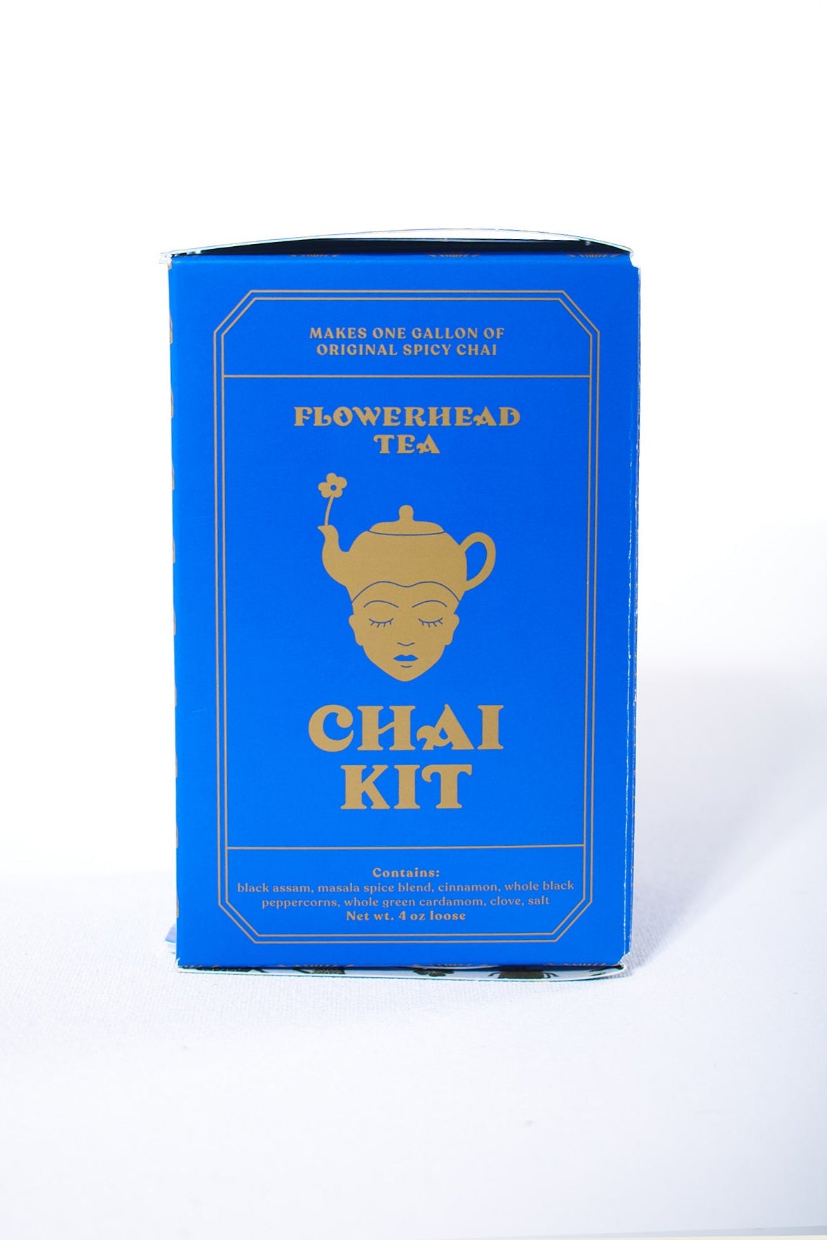 A blue box of Flowerhead Tea Chai Kit with a gold and white label design.