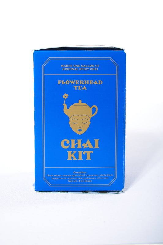 A blue box of Flowerhead Tea Chai Kit with a gold and white label design.