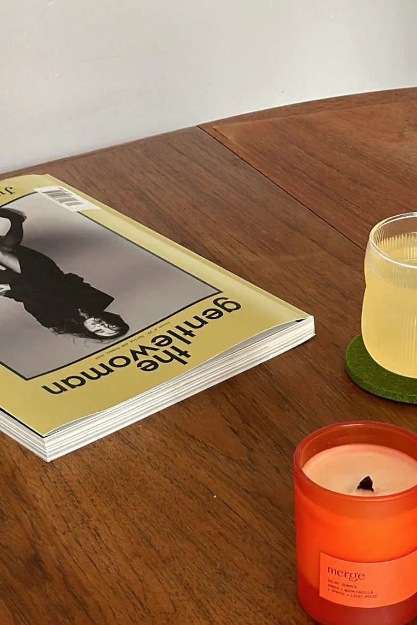 natural scented soy candle hand poured in amber glass on table in lifestyle shoot