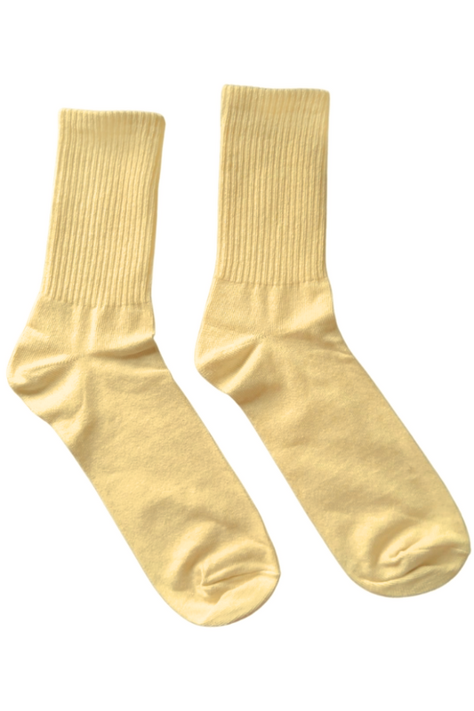 Pair of yellow socks on a white background