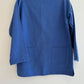 Blue jacket on a hanger against a white background