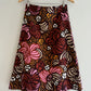 Skirt with a floral pattern on a hanger against a white background