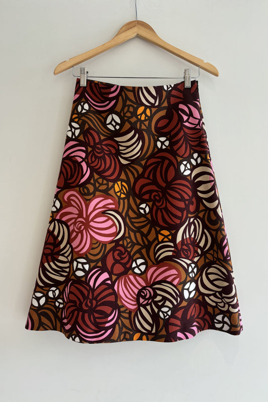 Skirt with a floral pattern on a hanger against a white background