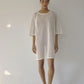 Bohème Goods Fisherman Tee in cream shown full length against a white studio background, showing open net cotton knit, relaxed oversized silhouette and mid-length hem with jelly sandals