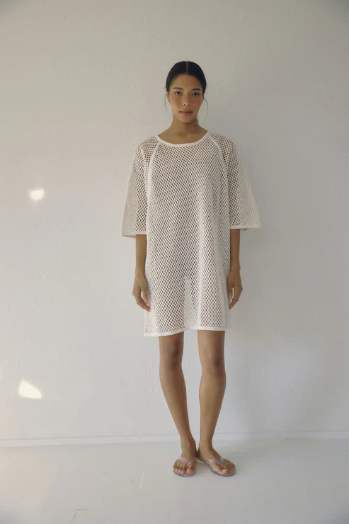 Bohème Goods Fisherman Tee in cream shown full length against a white studio background, showing open net cotton knit, relaxed oversized silhouette and mid-length hem with jelly sandals