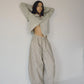 Bohème Goods Stripe Barrel Pant in sage and cream cotton stripe styled with an open grey cardigan, showing full barrel leg volume and elastic waist against a white studio background