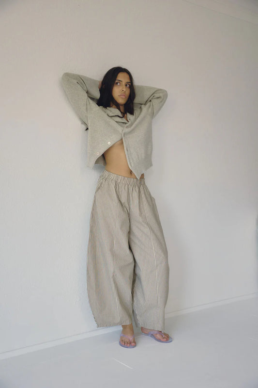 Bohème Goods Stripe Barrel Pant in sage and cream cotton stripe styled with an open grey cardigan, showing full barrel leg volume and elastic waist against a white studio background