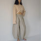 Bohème Goods Stripe Barrel Pant in sage and cream cotton stripe worn full length with a knotted blush knit cardigan and jelly sandals, showing relaxed barrel silhouette and elastic waist