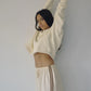 Side profile of Bohème Goods Track Short in cream showing vintage-inspired brown side stripe detail and relaxed cotton silhouette, styled with a cropped cream sweatshirt