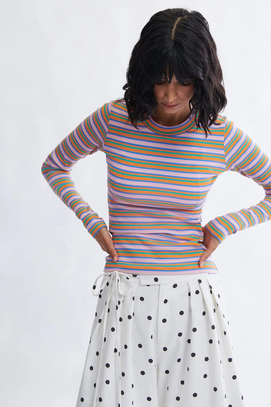 Woman wearing the Jamie fitted ribbed long sleeve top in pink stripe by Eliza Faulkner — ethically made in Canada, available at Ånde