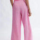 Woman wearing the Miranda Trouser in bubblegum linen-cotton blend by Eliza Faulkner — wide leg summer trousers at Ånde slow fashion store
