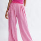 Woman wearing the Miranda Trouser in Bubblegum Linen- cotton blend by Eliza Faulkner - wide leg summer trousers at Ånde slow fashion store 