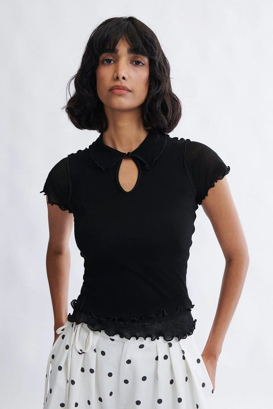 Woman wearing the Percy Polo Top in black by Eliza Faulkner — double-layered lyocell wool blend, ethically made in Canada at Ånde