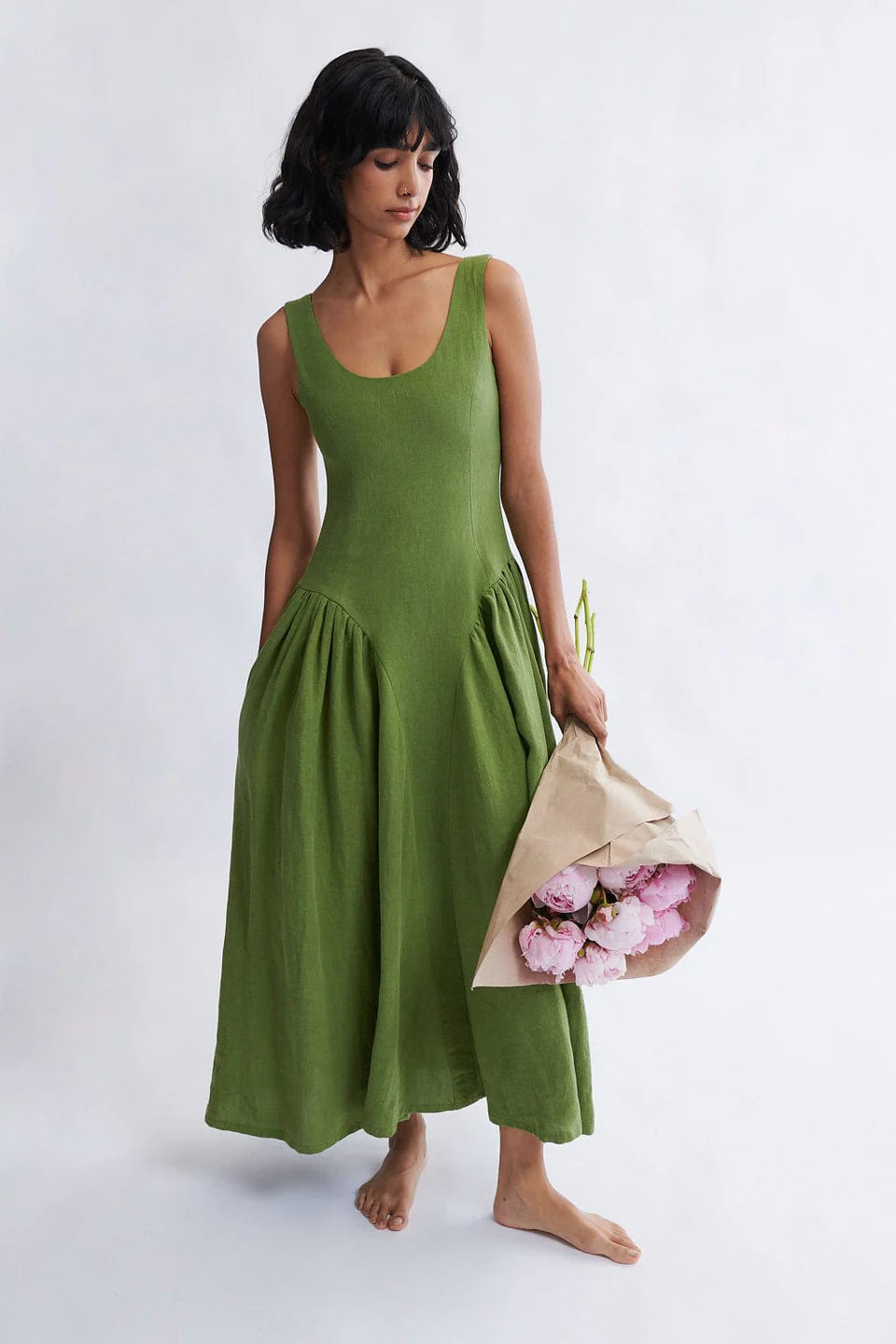 Woman wearing the Vivienne Linen Midi Dress in Meadow green by Eliza Faulkner, available at Ånde sustainable women's fashion store