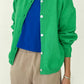 Le Bon Shoppe Cotton Leila Cardigan in spring green worn open over a cobalt blue tee and cream trousers, showing relaxed fit and standard length