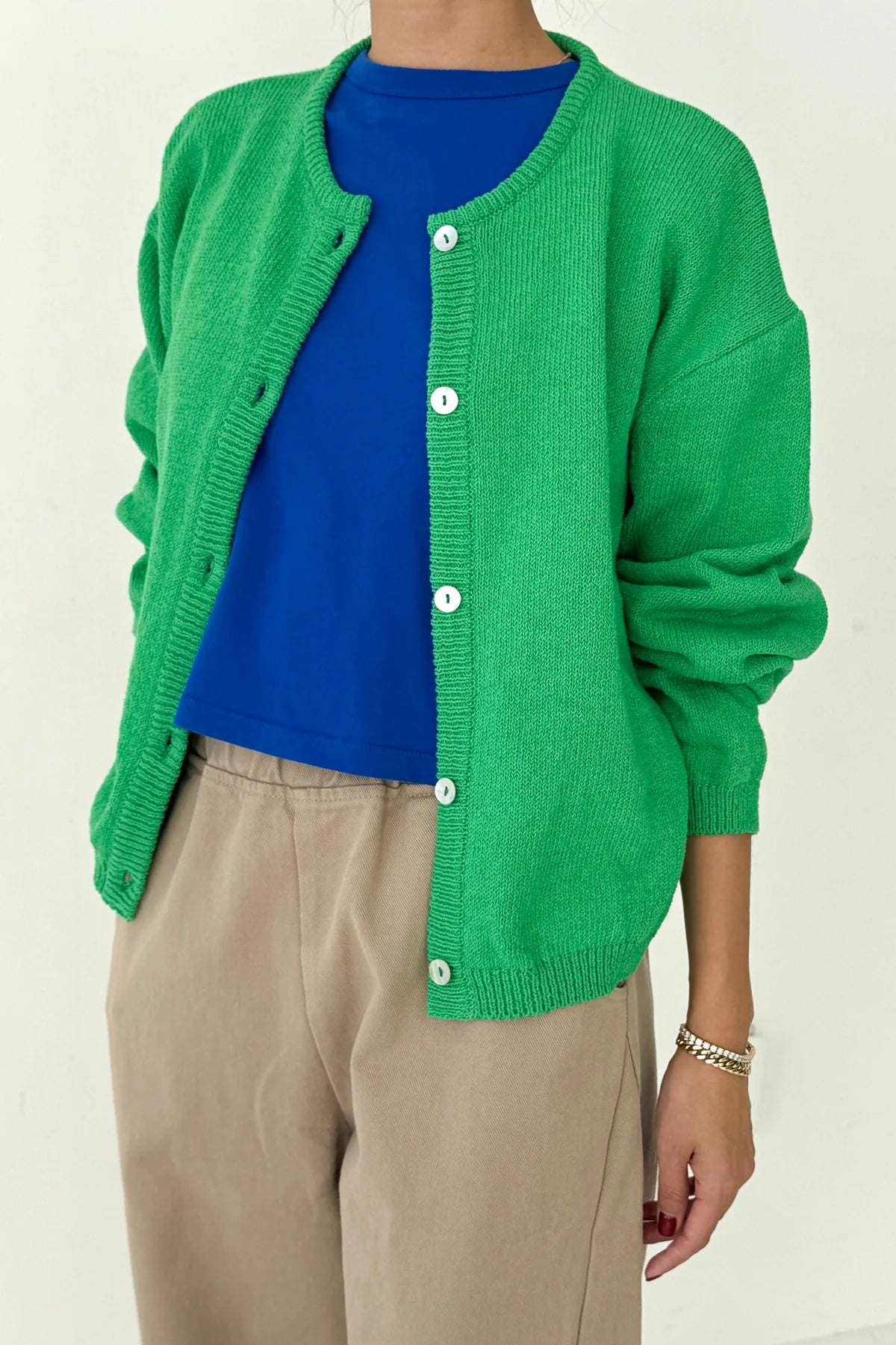 Le Bon Shoppe Cotton Leila Cardigan in spring green worn open over a cobalt blue tee and cream trousers, showing relaxed fit and standard length