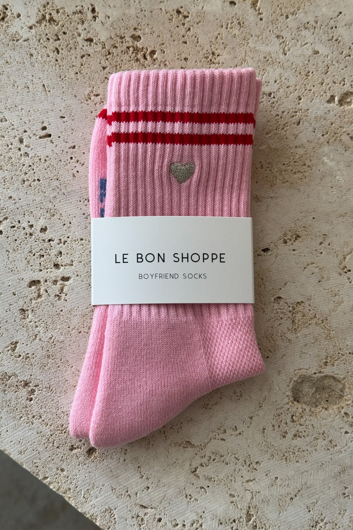 Le Bon Shoppe Embroidered Boyfriend Socks in amour pink folded and banded with Le Bon Shoppe Boyfriend Socks packaging label, showing embroidered heart and red double stripe on pink ribbed cotton