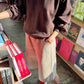 Le Bon Shoppe French Terry Core Sweatshirt in cocoa bean styled over a colour-block midi skirt with red ribbed socks and white heels in a bookstore setting