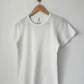 Le Bon Shoppe Go-To Tee in vintage white on a wooden hanger against a white wall, showing relaxed longer length silhouette, crew neck and short sleeves