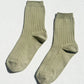 Pair of Le Bon Shoppe Her Socks in avocado green laid flat on a white surface, showing the ribbed cotton-blend texture and quarter-crew length