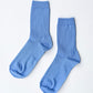 Pair of Le Bon Shoppe Her Socks in periwinkle laid flat on a white surface, showing ribbed cotton-blend texture and quarter-crew length