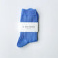 Le Bon Shoppe Her Socks in periwinkle folded and banded with branded Le Bon Shoppe packaging label, displayed on a light grey surface