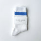 Le Bon Shoppe Her Varsity Socks in periwinkle folded and banded with Le Bon Shoppe Her Socks packaging label, showing periwinkle double stripe on white ribbed cotton on a light grey surface