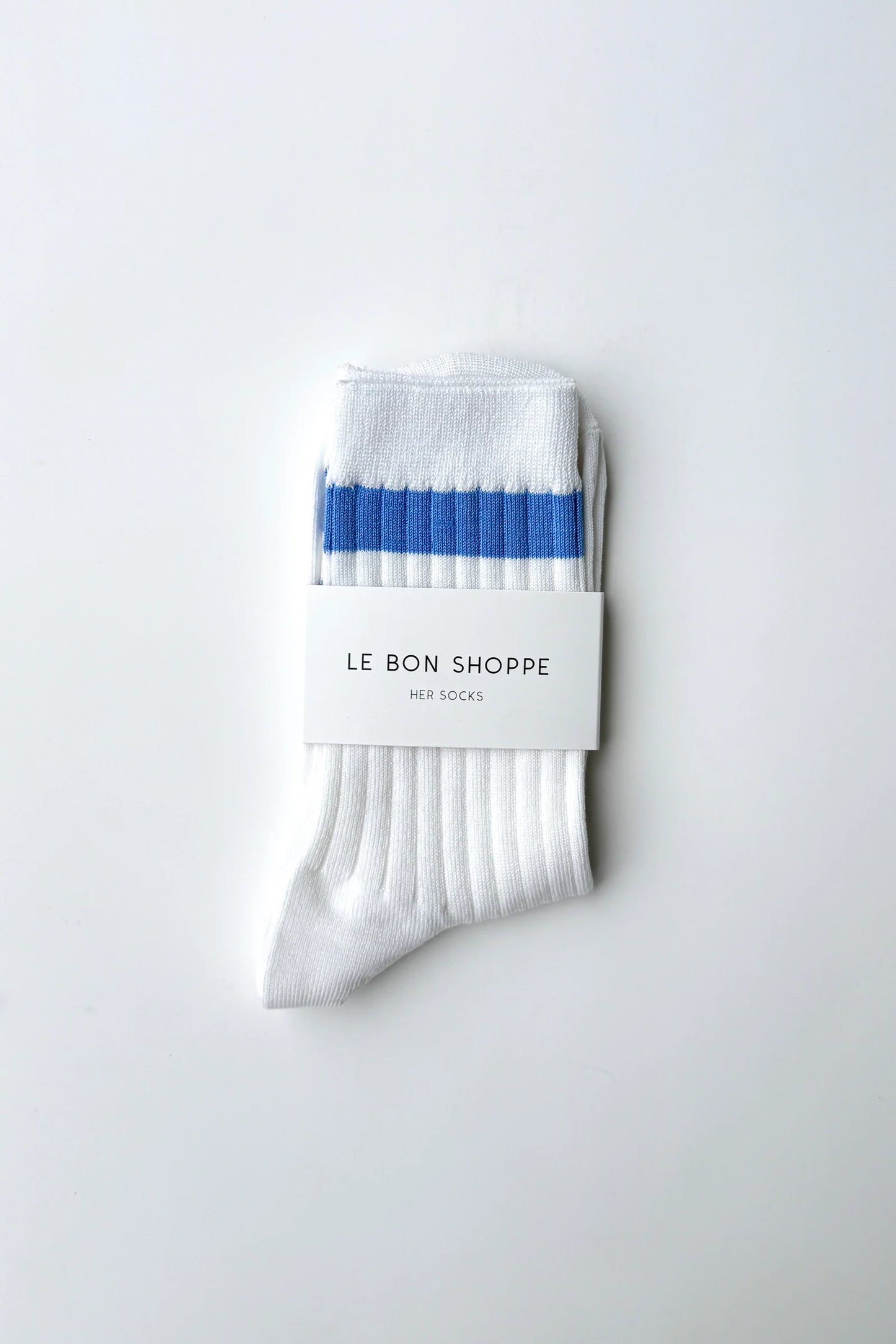 Le Bon Shoppe Her Varsity Socks in periwinkle folded and banded with Le Bon Shoppe Her Socks packaging label, showing periwinkle double stripe on white ribbed cotton on a light grey surface