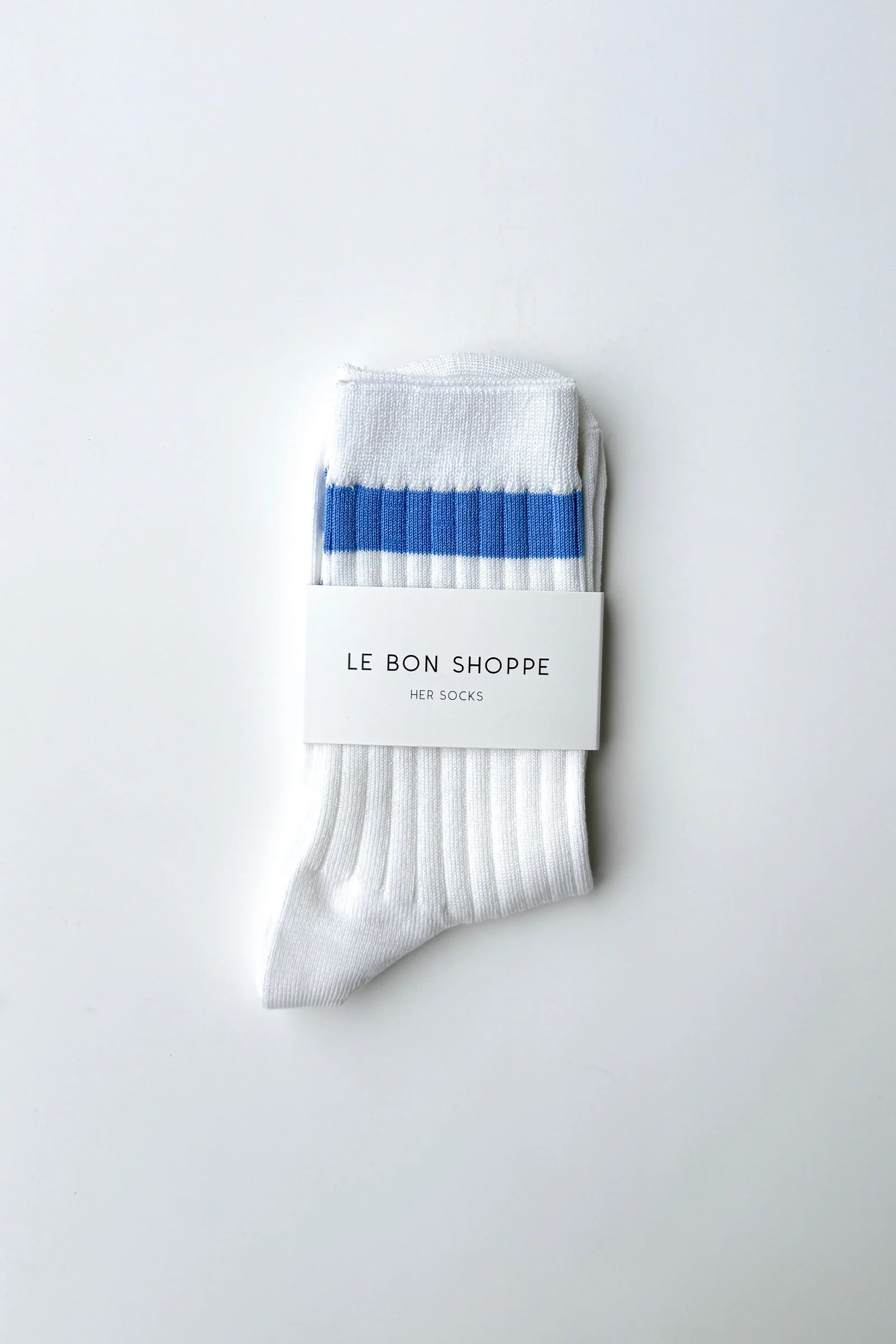 Le Bon Shoppe Her Varsity Socks in periwinkle folded and banded with Le Bon Shoppe Her Socks packaging label, showing periwinkle double stripe on white ribbed cotton on a light grey surface