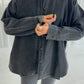 Le Bon Shoppe Theo Jacket in black denim buttoned up showing oversized fit and cuff detail, styled with grey ribbed knit trousers against a light studio background