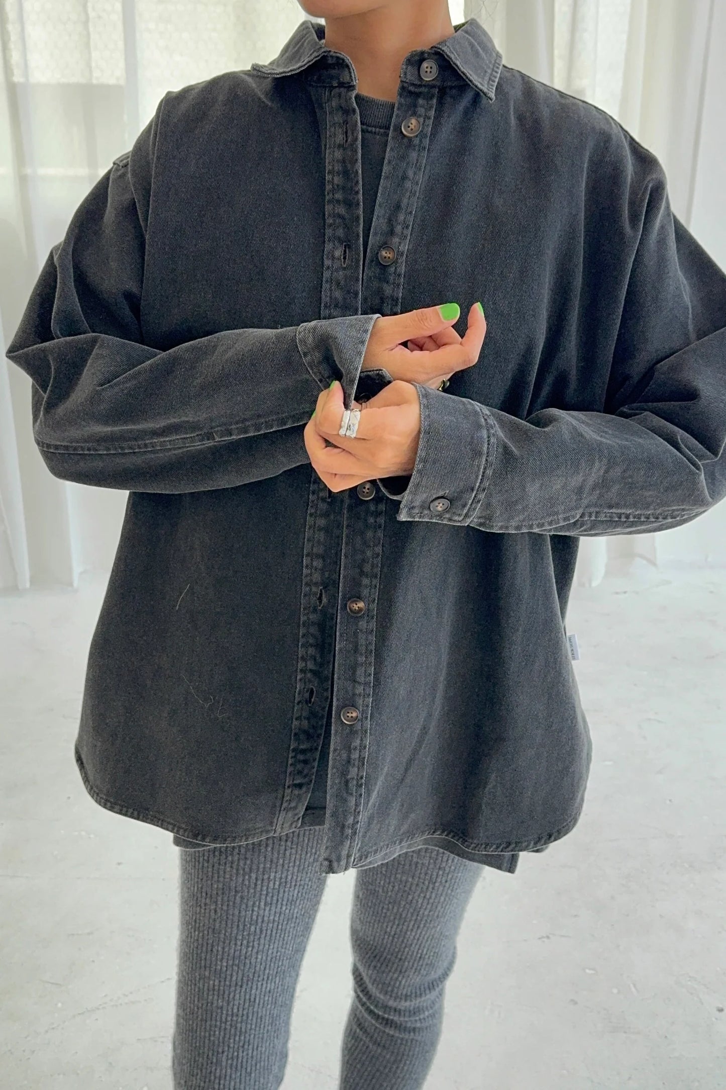 Le Bon Shoppe Theo Jacket in black denim buttoned up showing oversized fit and cuff detail, styled with grey ribbed knit trousers against a light studio background