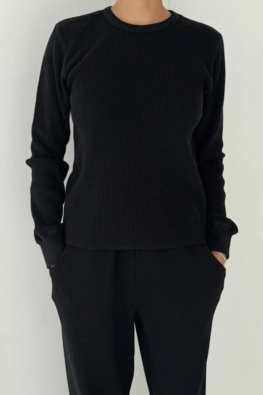Le Bon Shoppe Waffle Fundamental Tee in true black worn as a coordinated set with the Waffle Lo Pants, showing heavyweight waffle cotton texture and close easy fit against a white studio background