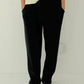 Le Bon Shoppe Waffle Lo Pants in true black full length front view showing relaxed wide leg silhouette, elastic waist and front pockets, styled with cream Waffle Fundamental Tee and navy sneakers
